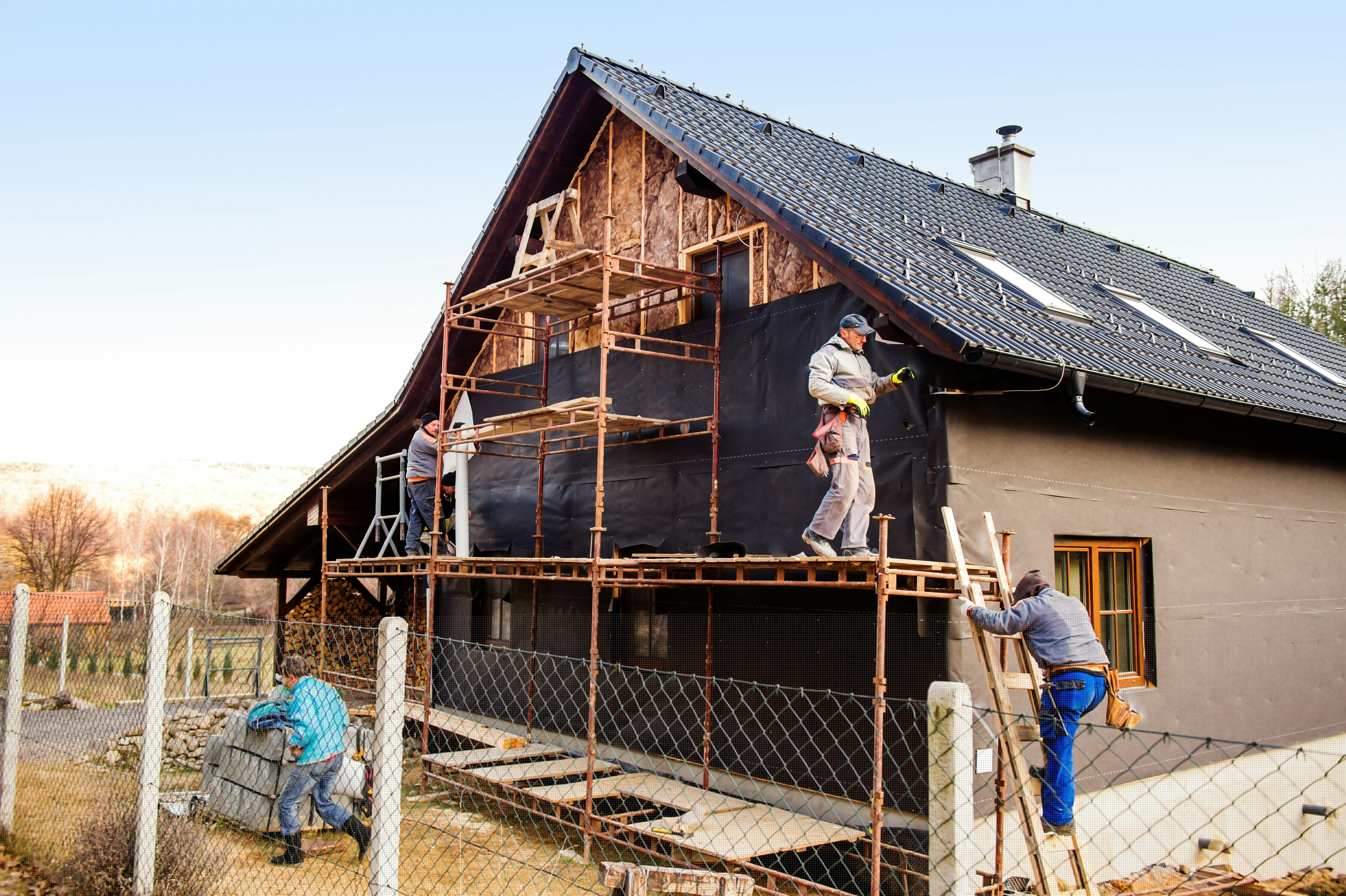 Construction workers standing on a scaffold